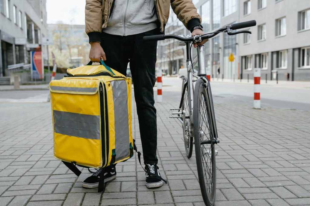 man carrying a yellow bag